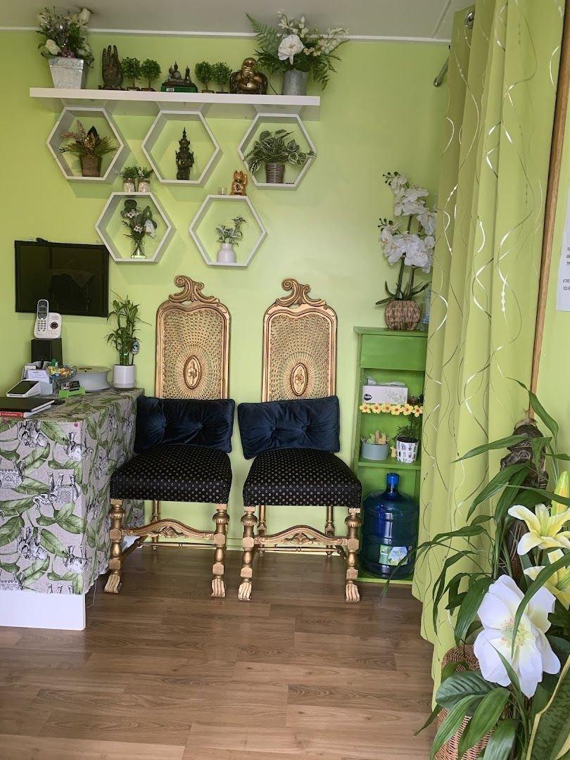 Cozy reception area with green walls and elegant chairs